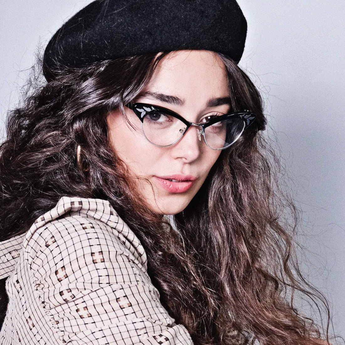 Model wearing black and silver cat-eye glasses