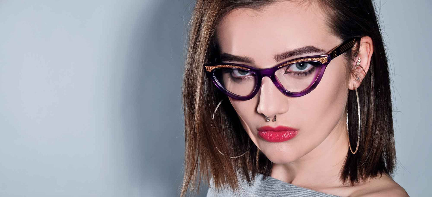 Purple cat eye glasses on a gorgeous model with hoop earings