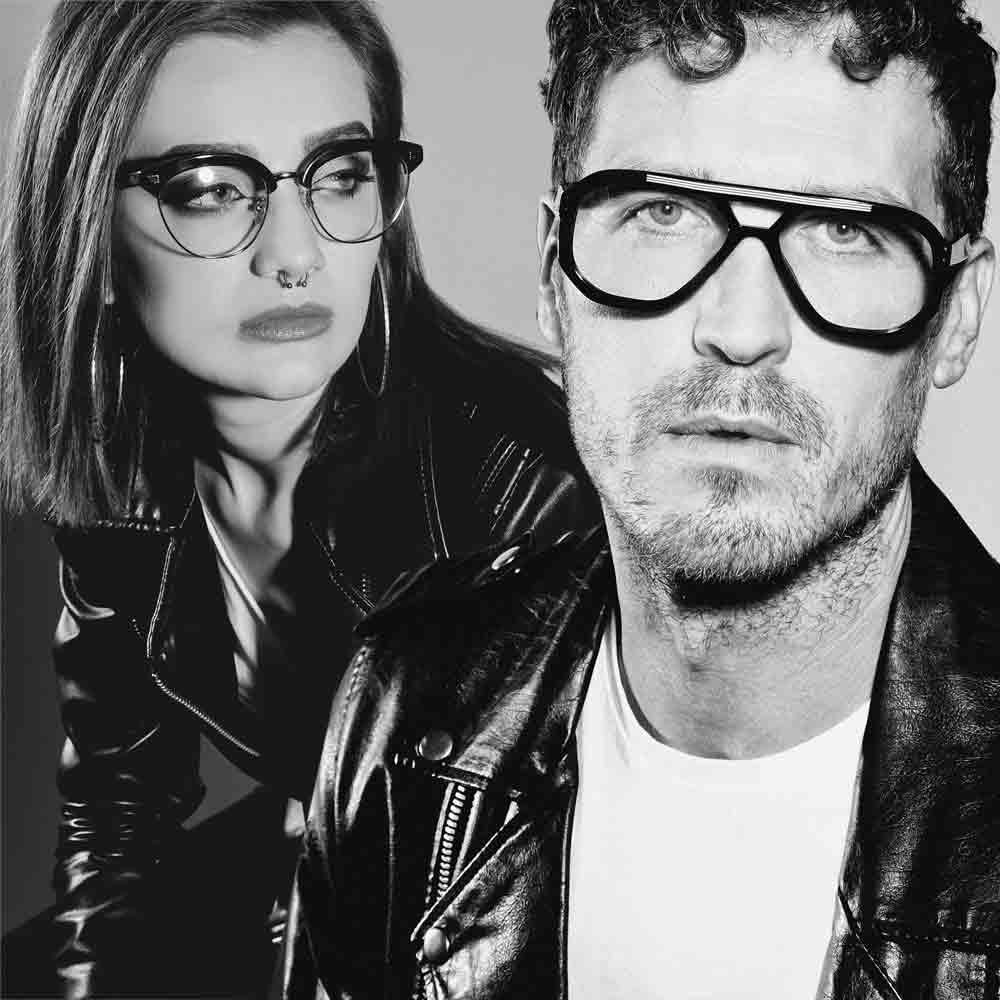 Two people wearing black eyeglasses in a black and white photo