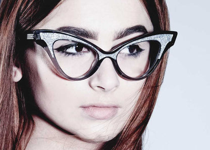 Model wearing black at eye glasses with red hair.