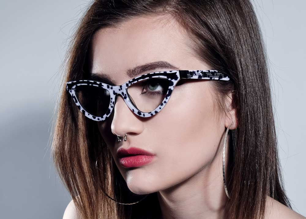 Model wearing dalmatian print glasses frames