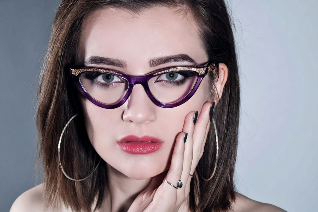 Lady wearing purple cat eye glasses with gold glitter brow
